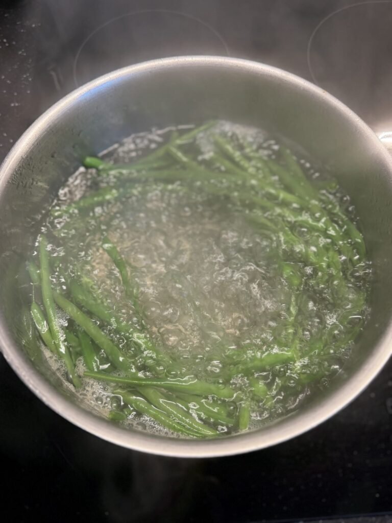green beans in rolling boiling salted water
