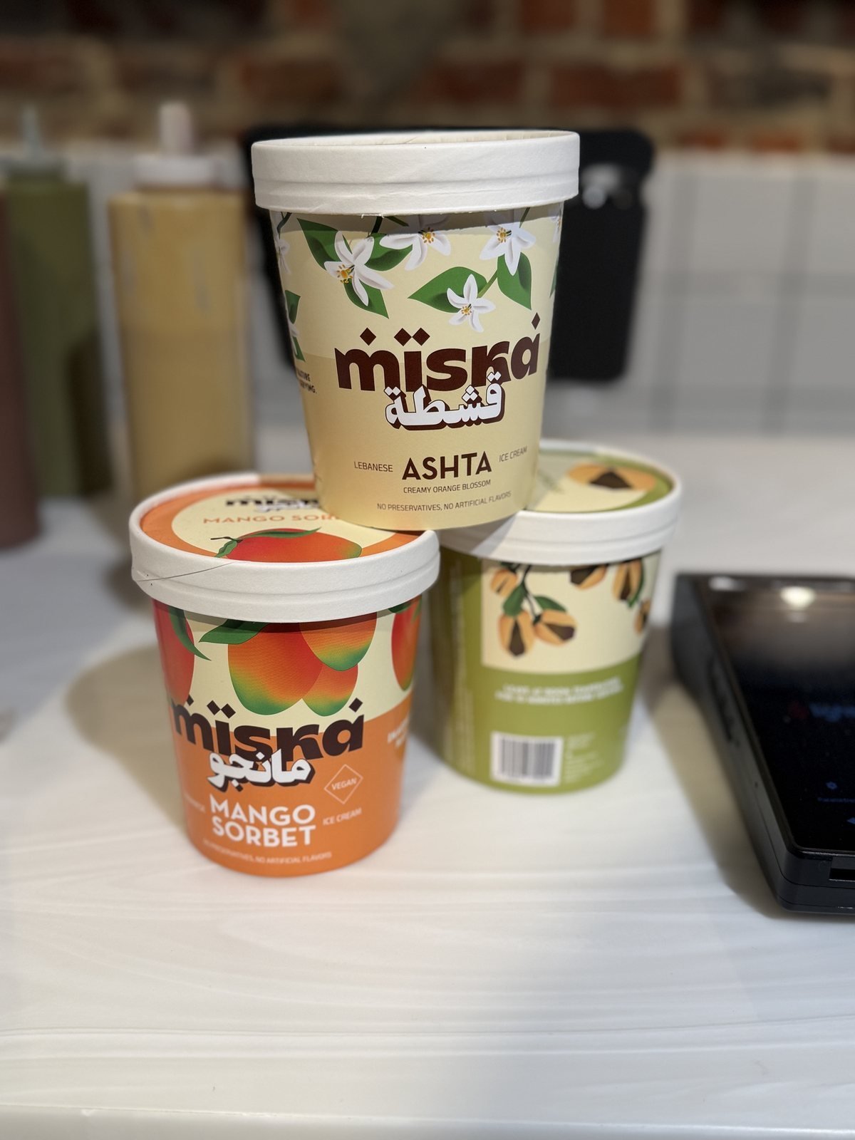 Miska take-home tubs: ashta, mango sorbet and pistachio